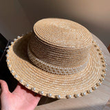Load image into Gallery viewer, Spring and summer Korean version handmade pearl straw woven flat top hat wheat straw straw hat versatile flat edge hat seaside sun protection hat