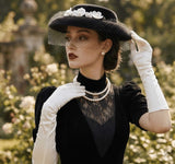 Load image into Gallery viewer, icevellyyy black felt vintage-inspired hat with veil and floral embellishment, worn by a model with white gloves and pearls.