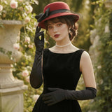 Load image into Gallery viewer, icevellyyy black velvet evening gown with sweetheart neckline and long gloves, paired with a red hat and pearls.