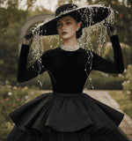 Load image into Gallery viewer, Black velvet wide-brimmed hat with pearl and silver bead embellishments, worn by a model with a pearl necklace.