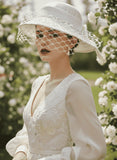 Load image into Gallery viewer, icevellyyy white satin-like wide-brimmed hat with netting veil, bow, and floral embroidery. Perfect for weddings.