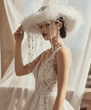 Load image into Gallery viewer, icevellyyy white wide-brimmed bridal hat with feathers and pearl accents, worn by a model in a lace wedding dress.